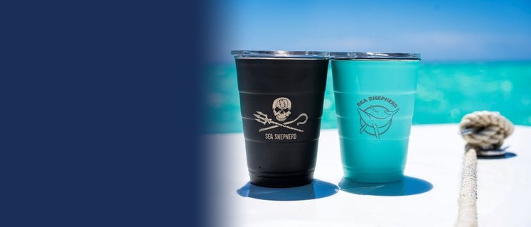 Branded tumblers from Sea Shepherd on a boat by the sea